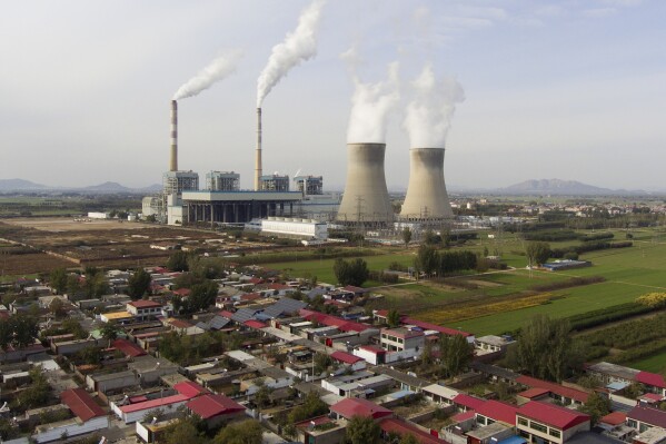 Guohua Power Station, a coal-fired power plant, operates in Dingzhou, Baoding, in the northern China's Hebei province, Friday, Nov. 10, 2023. The world is off track in its efforts to curb global warming, a new international report calculates Tuesday, Nov. 14. (AP Photo/Ng Han Guan)