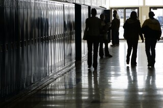 FILE - Students walk down a hallway at a high school in Iowa, Dec. 19, 2006. West Virginia's Republican-majority Senate green-lit a bill Tuesday, Feb. 27, 2024, that would make a video on fetal development funded by an anti-abortion group to be required viewing in public schools. (Scott Morgan/The Hawk Eye via AP, File)