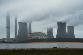 FILE - This June 1, 2014, file photo show the coal-fired Plant Scherer in operation in Juliette, Ga. Despite what President Donald Trump says, scientists have long known that what's warming the planet isn't natural. It's us. Climate scientists say Trump was wrong. There are several ways they know that more than 90 percent of climate change is caused by emissions of heat-trapping gases from activities like burning coal and natural gas for electricity, or burning gasoline, diesel and jet fuel for transportation. In other words, humans. (AP Photo/John Amis, File)