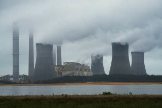 
              FILE - This June 1, 2014, file photo show the coal-fired Plant Scherer in operation in Juliette, Ga. Despite what President Donald Trump says, scientists have long known that what's warming the planet isn't natural. It's us. Climate scientists say Trump was wrong. There are several ways they know that more than 90 percent of climate change is caused by emissions of heat-trapping gases from activities like burning coal and natural gas for electricity, or burning gasoline, diesel and jet fuel for transportation. In other words, humans. (AP Photo/John Amis, File)
            