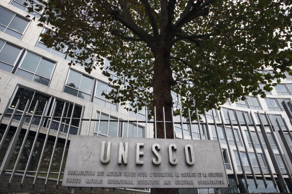 FILE - The United Nations Educational Scientific and Cultural Organization logo is pictured on the entrance at UNESCO's headquarters in Paris, Oct. 17, 2016. A White House official says President Joe Biden will nominate a top aide to both Vice President Kamala Harris and her husband, Doug Emhoff, to represent the United States at the United Nations agency devoted to education, science and culture. Courtney O'Donnell is Biden's choice to become the U.S. permanent representative, with the rank of ambassador, to the Paris-based UNESCO. (AP Photo/Francois Mori, File)