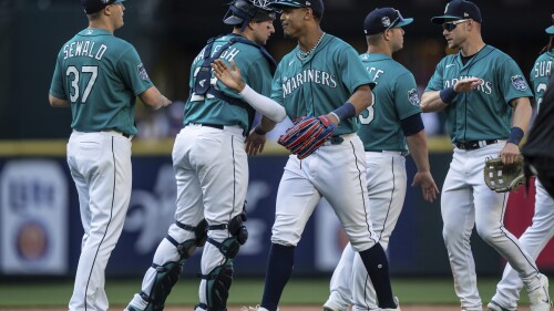 From left to right, Seattle Mariners relief pitcher Paul Sewald, catcher Cal Raleigh, centerfielder Julio Rodriguez, first baseman Ty France and left fielder Jarred Kelenic celebrate after a baseball game against the Tampa Bay Rays, Saturday, July 1, 2023, in Seattle. (AP Photo/Stephen Brashear)