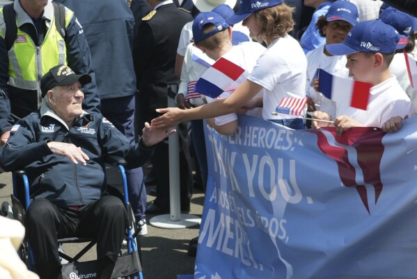 An American D-Day veteran is welcomed at Deauville airport, Monday, June 3, 2024 in Deauville, Normandy to attend D-Day 80th anniversary commemorations. (AP Photo/Alexander Turnbull)