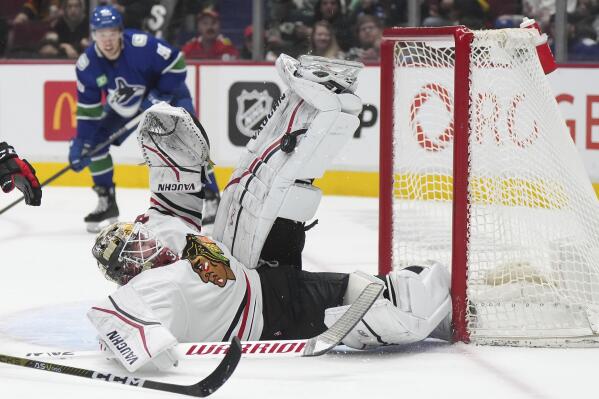 Chicago Blackhawks goalie Alex Stalock stops Vancouver Canucks' Anthony Beauvillier, not seen, during the second period of an NHL hockey game Thursday, April 6, 2023, in Vancouver, British Columbia. (Darryl Dyck/The Canadian Press via AP)