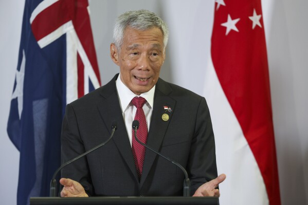 FILE - Singapore Prime Minister Lee Hsien Loong gestures during a joint press conference with Australian Prime Minister Anthony Albanese following a bilateral meeting at the ASEAN-Australia Special Summit in Melbourne, Australia on March 5, 2024. Lee will relinquish his office on May 15 and hand the post to his deputy Lawrence Wong, his office said Monday, April 15, 2024. (AP Photo/Hamish Blair, File)