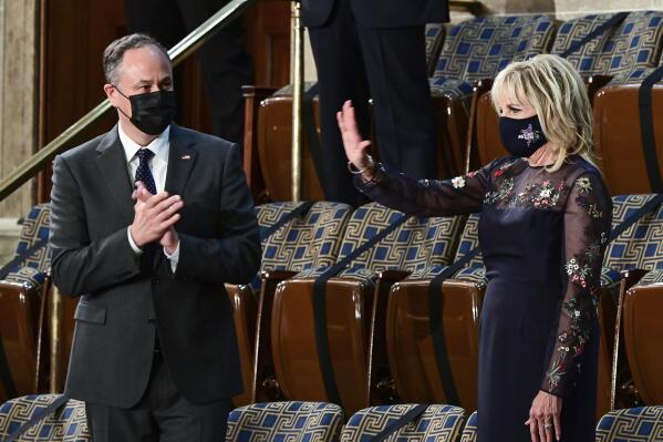 First lady Jill Biden waves as she arrives prior to President Joe Biden arriving to address a joint session of Congress, Wednesday, April 28, 2021, in the House Chamber at the U.S. Capitol in Washington, as Doug Emhoff looks on. (Jim Watson/Pool via AP)