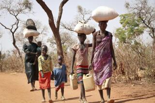 File - After walking for days, a refugee family arrives in Yida, South Sudan, Feb. 20, 2018. South Sudan's president on Wednesday, Feb. 22, 2023, urged the country's more than 2 million refugees to return home in his first meeting with displaced people since civil war erupted almost a decade ago. (AP Photo/Sam Mednick, file)