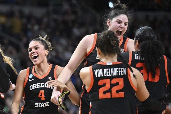 Oregon State players celebrate after defeating Notre Dame in a Sweet Sixteen round college basketball game during the NCAA Tournament, Friday, March 29, 2024, in Albany, N.Y. (AP Photo/Hans Pennink)