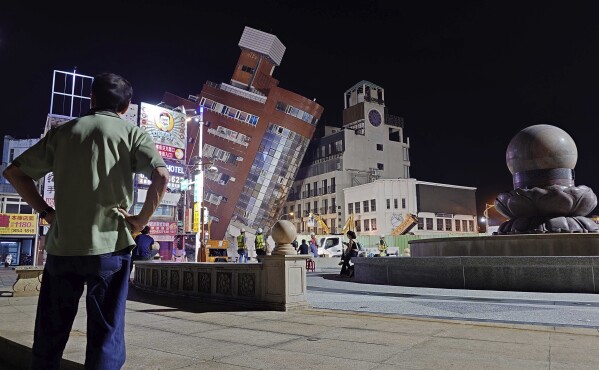 A man looks at the cordoned off site of a leaning building in the aftermath of an earthquake in Hualien, eastern Taiwan on Wednesday, April 3, 2024. Taiwan's strongest earthquake in a quarter century rocked the island during the morning rush hour Wednesday, damaging buildings and highways (AP Photo/Chiang Ying-ying)
