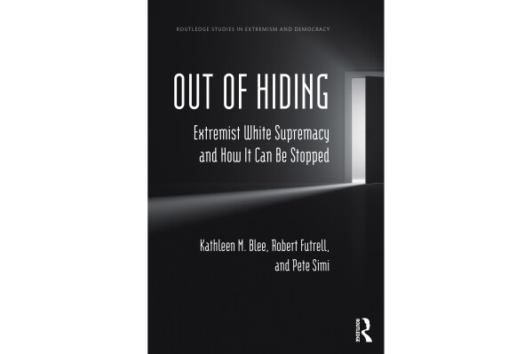 This image released by Routledge shows "Out of Hiding, Extremist White Supremacy and How it Can Be Stopped" by Kathleen M. Blee, Robert Futrell and Pete Simi. (Routledge via AP)
