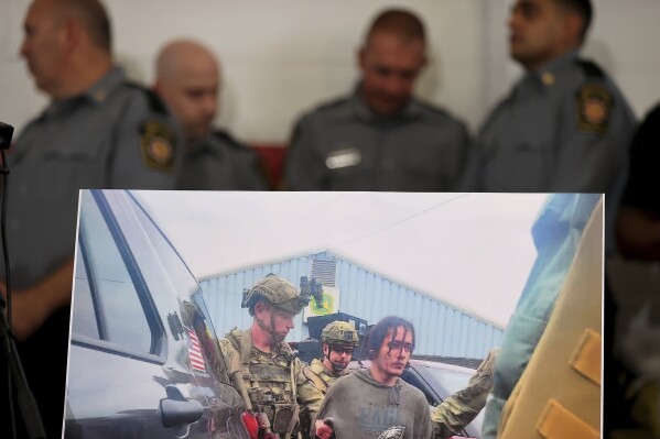 A photo showing Danelo Souza Cavalcante in custody sits on display during a news conference in Kennett Square, Pa. on Wednesday, Sept. 13, 2023. Cavalcante was captured Wednesday after eluding hundreds of searchers for two weeks. (David Maialetti/The Philadelphia Inquirer via AP)