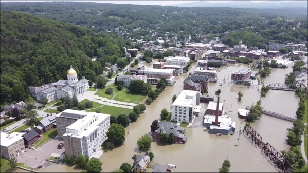 FILE — This image made from drone footage provided by the Vermont Agency of Agriculture, Food and Markets shows flooding in Montpelier, Vt., Tuesday, July 11, 2023. The Vermont legislature is advancing a bill that would require fossil fuel producers to pay for some of the state's recovery costs from climate-related storms. (Vermont Agency of Agriculture, Food and Markets via AP, File)