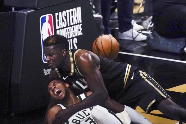Milwaukee Bucks forward Giannis Antetokounmpo (34) and Atlanta Hawks center Clint Capela fall to the court during the second half of Game 4 of the NBA basketball Eastern Conference finals Tuesday, June 29, 2021, in Atlanta. (AP Photo/Brynn Anderson)