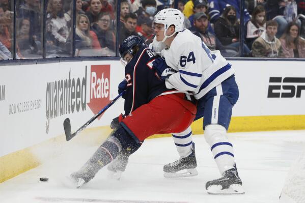 Columbus Blue Jackets' Jake Bean, left, keeps the puck away from Toronto Maple Leafs' David Kampf during the first period of an NHL hockey game Monday, March 7, 2022, in Columbus, Ohio. (AP Photo/Jay LaPrete)