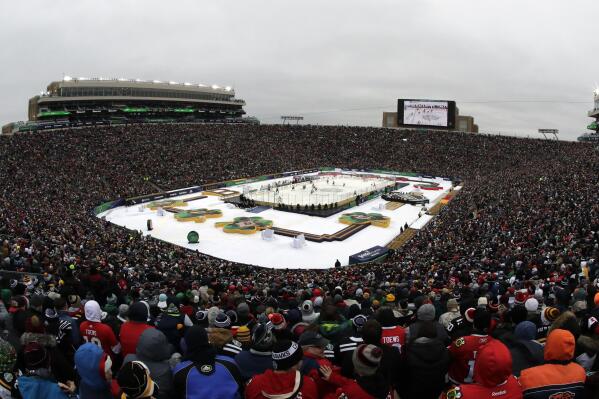 THIS CORRECTS THAT ALDRICH VOLUNTEERED AT HOUGHTON HIGH SCHOOL AND NOT HANCOCK HIGH SCHOOL AS ORIGINALLY SENT -  FILE - Notre Dame Stadium is viewed during the second period of the NHL Winter Classic hockey game between the Boston Bruins and the Chicago Blackhawks, Jan. 1, 2019, in South Bend, Ind. Before arriving at Houghton High School, as a volunteer coach, Brad Aldrich had been allowed to resign from the Blackhawks over accusations of sexually assaulting a player. Aldrich worked for the University of Notre Dame and Miami University in Ohio before spending time as a volunteer coach in his native Michigan. (AP Photo/Nam Y. Huh, File)