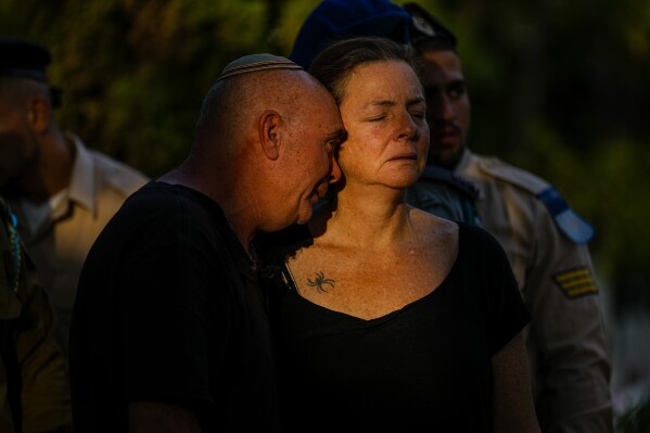 Doron and Tami, parents of Israeli reserve soldier captain Omri Yosef David, mourn during his funeral in Carmiel, Israel, Wednesday, Nov. 15, 2023. David, 27, was killed during a military ground operation in the Gaza Strip. (AP Photo/Ariel Schalit)