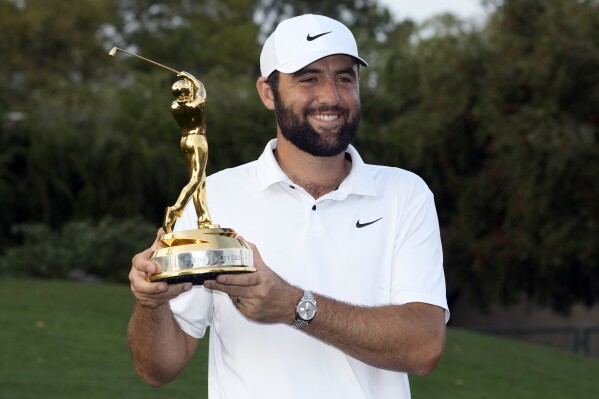 Scottie Scheffler holds up the trophy after winning The Players Championship golf tournament Sunday, March 17, 2024, in Ponte Vedra Beach, Fla. (AP Photo/Lynne Sladky)