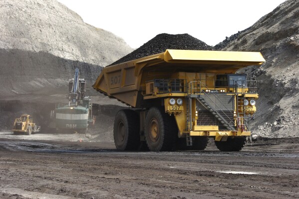 FILE - A truck carrying 250 tons of coal hauls the fuel to the surface of the Spring Creek mine, April 4, 2013, near Decker, Mont. The Biden administration is proposing to end new coal leases from federal lands in the Powder River Basin of Montana and Wyoming, which includes Spring Creek. (AP Photo/Matthew Brown, File)