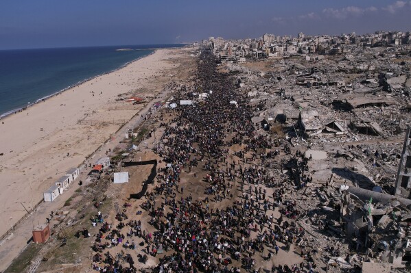 Displaced Palestinians return to their homes in the northern Gaza Strip on Monday, Jan. 27, 2025, following Israel's decision to allow thousands of them to go back for the first time since the early weeks of the 15-month war with Hamas. (AP Photo/Mohammad Abu Samra)