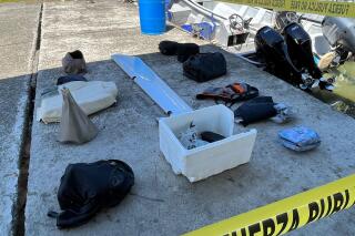 This handout photo provided by Costa Rica's Public Security Ministry shows flight passengers' personal belongings recovered from Caribbean waters along with pieces of a twin-engine turboprop aircraft, in Limon, Costa Rica, Saturday, Oct. 22, 2022. Six people, apparently including a German business magnate, were feared dead Saturday after the small plane crashed into the Caribbean just off the Costa Rican coast. (Costa Rica Public Security Ministry Photo via AP)