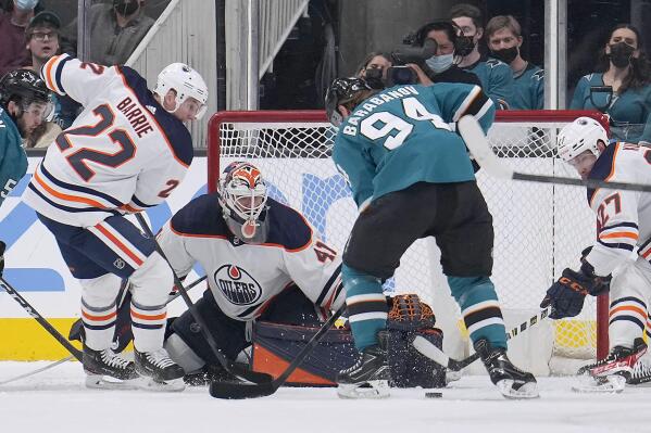 Edmonton Oilers goaltender Mike Smith (41) blocks a shot by San Jose Sharks left wing Alexander Barabanov (94) as Tyson Barrie (22) defends during the second period of an NHL hockey game Tuesday, April 5, 2022, in San Jose, Calif. (AP Photo/Tony Avelar)