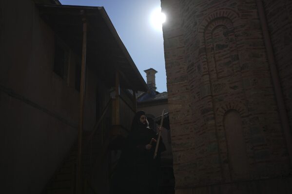 Father Simon uses a mallet and plank to summon monks and visitors to afternoon prayers at the Simonopetra, or Simonos Petra Monastery, home of the all-male autonomous community of Agion Oros, or Holy Mountain, on the peninsula of Mount Athos in northern Greece, April 13, 2025. (AP Photo/Thanassis Stavrakis)