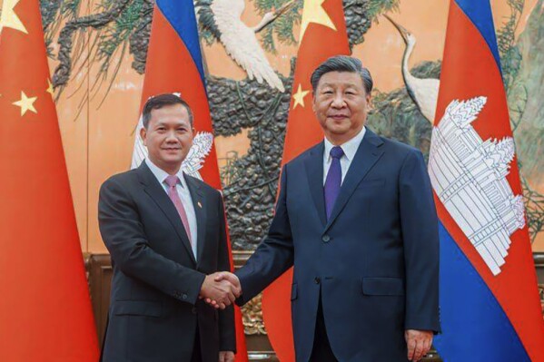 In this photo provided by Cambodia's Prime Minister Telegram, Cambodian Prime Minister Hun Manet, left, shakes hands with Chinese President Xi Jinping, right, during a welcome ceremony in Beijing, China, Friday, Sept. 15, 2023. (Cambodia's Prime Minister Telegram via AP)