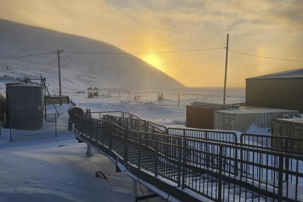 FILE - A walkway leading into the school in Wales, Alaska, where a 24-year-old woman and her 1-year-old son were killed in an encounter with a polar bear, Jan. 17, 2023. A polar bear that killed a young mother and her baby on Jan. 17, in western Alaska was likely an older bear in poor body condition, but officials say tests were negative for pathogens that affect the brain and cause aggressive behavior. (Chrissy Friberg via AP, File)