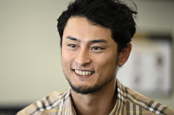 Yu Darvish of the San Diego Padres poses for a photo with a fan