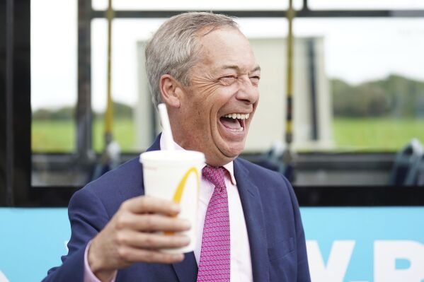 Leader of Reform UK Nigel Farage holds a McDonalds banana milkshake in Jaywick, Essex, England, Tuesday June 4, 2024. Mr Farage announced on Monday that he will stand for parliament in Clacton and lead Reform UK for the next five years. (James Manning/PA via AP)