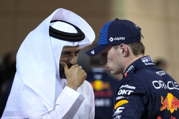 Red Bull driver Max Verstappen of the Netherlands, center, who qualified for pole position, speaks with FIA President Mohammed Ben Sulayem after qualification ahead of the Formula One Bahrain Grand Prix at the Bahrain International Circuit in Sakhir, Bahrain, Friday, March 1, 2024. (AP Photo/Darko Bandic)