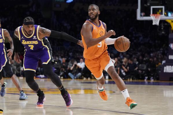 Phoenix Suns guard Chris Paul (3) dribbles past Los Angeles Lakers forward Carmelo Anthony during the first half of an NBA basketball game Friday, Oct. 22, 2021, in Los Angeles. (AP Photo/Marcio Jose Sanchez)