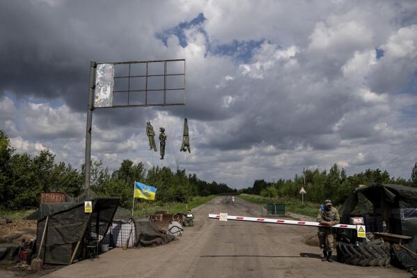 Effigies depicting Russian soldiers hang at a checkpoint in the Kharkiv region, Ukraine, Saturday, July 23, 2022. (AP Photo/Evgeniy Maloletka)