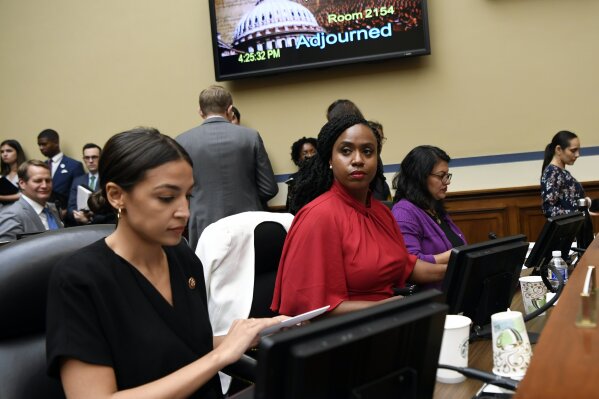 Rep. Alexandria Ocasio-Cortez, D-N.Y., left, Rep. Ayanna Pressley, D-Mass., center, and Rep. Rashida Tlaib, D-Mich., right, gather their things following the adjournment of a House Oversight Committee hearing on Capitol Hill in Washington, Monday, July 15, 2019, on White House counselor Kellyanne Conway's violation of the Hatch Act. (AP Photo/Susan Walsh)