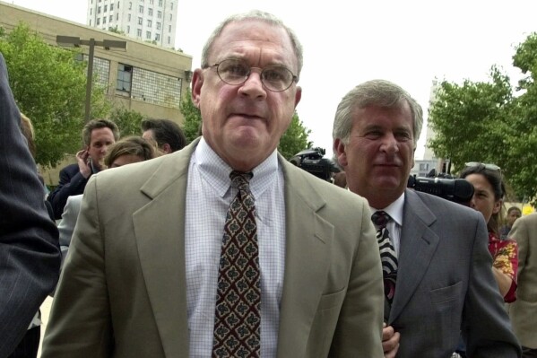 FILE - Rabbi Fred J. Neulander, left, a prominent southern New Jersey Rabbi who has been charged with hiring two men to kill his wife, walks with his attorneys to the Camden County Courthouse for arraignment on capitol murder charges in Camden, N.J., Wednesday, June 21, 2000. Neulander, 82, a New Jersey rabbi serving a decadeslong sentence in a 1994 murder-for-hire plot targeting was pronounced dead shortly after 6 p.m., Wednesday, April 17, 2024, at a hospital in Trenton, N.J., after he was found unresponsive in his cell in the New Jersey State Prison infirmary, news outlets reported, citing the state department of corrections. (AP Photo/Charles Rex Arbogast, File)