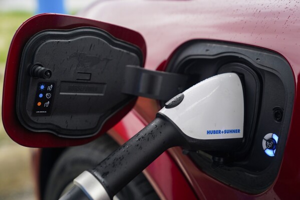 A 2023 Ford Mustang Mach-E charges, March 8, 2024, at an electric vehicle charging station in London, Ohio. (AP Photo/Joshua A. Bickel, File)