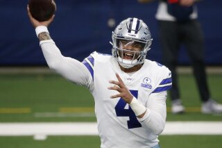 FILE - In this Oct. 11, 2020, file photo, Dallas Cowboys quarterback Dak Prescott throws a pass in the first half of an NFL football game against the New York Giants in Arlington, Texas. The Cowboys and Prescott have finally agreed on a contract two years after negotiations began with the star quarterback. The team the agreement was reached Monday, March 8, 2021, with further details to be announced. (AP Photo/Michael Ainsworth, File)