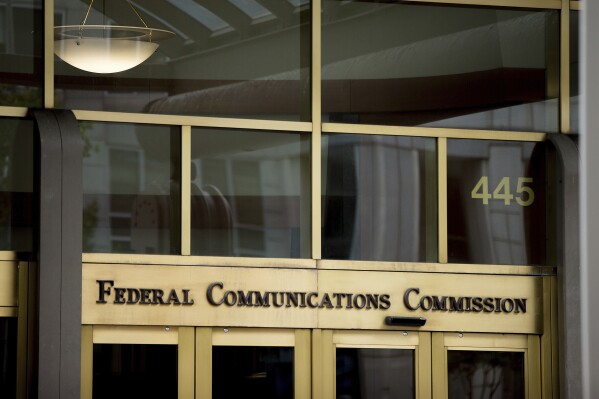 FILE - This June 19, 2015, file photo, shows the Federal Communications Commission building in Washington. The FCC has leveraged nearly $200 million in fines against wireless carriers AT&T, Sprint, T-Mobile and Verizon for illegally sharing customers’ location data without their consent. Officials first began investigating the carriers back in 2019 after they were found selling customers’ location data to third-party data aggregators. (AP Photo/Andrew Harnik, File)
