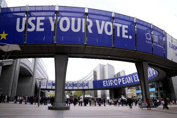 FILE - People wait in line to visit the European Parliament during Europe Day celebrations in Brussels on May 4, 2024. Voters in the European Union are set elect lawmakers for the bloc's parliament, in a major democratic exercise that's also likely to be overshadowed by online disinformation. Experts have warned about that artificial intelligence could supercharge the spread of fake news to disrupt the election in the EU and many other countries this year. (AP Photo/Virginia Mayo, File)