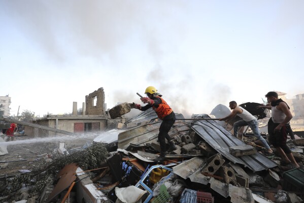 Palestinians look for survivors after an Israeli airstrike on Nusseirat refugee camp, Gaza Strip, Wednesday, Oct. 18, 2023. (AP Photo/Ali Mohmoud)