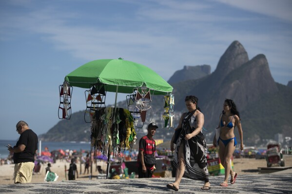 Beach fans will pass the beachwear at Vendor's Stand at Ipanema Beach, Rio de Janeiro on Sunday, May 25th, 2025 (AP Photo/Bruna Prado)
