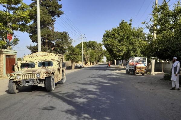 An Afghan army Humvee patrols in Kunduz city, north of Kabul, Afghanistan, Monday, June 21, 2021. Taliban fighters took control of a key district in Afghanistan's northern Kunduz province Monday and encircled Kunduz, the provincial capital, police said. (AP Photo/Abdullah Sahil)