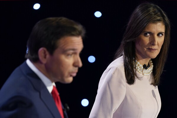 Former UN Ambassador Nikki Haley, right, looks at Florida Gov. Ron DeSantis, left, at the CNN Republican presidential debate at Drake University in Des Moines, Iowa, Wednesday, Jan. 10, 2024. (AP Photo/Andrew Harnik)