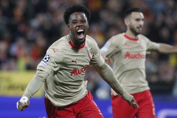 Lens' Elye Wahi celebrates after scoring his side's opening goal during the Champions League, Group B soccer match between Lens and PSV Eindhoven at the Bollaert-Delelis stadium in Lens, northern France, Tuesday, Oct. 24, 2023. (AP Photo/Michel Spingler)