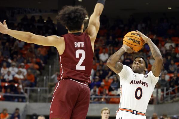 Auburn guard K.D. Johnson (0) shoots as Colgate guard Braeden Smith (2) defends during the second half of an NCAA college basketball game Friday, Dec. 2, 2022, in Auburn, Ala. (AP Photo/Butch Dill)