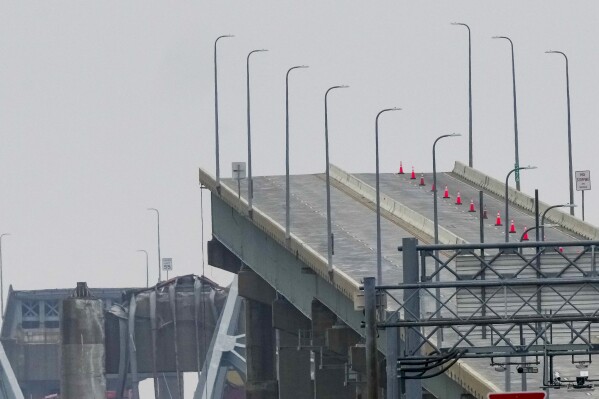Shown is the wreckage of Francis Scott Key Bridge as seen from Dundalk, Md., on Wednesday, March 27, 2024, Recovery efforts resumed Wednesday for the construction workers who are presumed dead after the cargo ship hit a pillar of the bridge, causing the structure to collapse. (AP Photo/Matt Rourke)