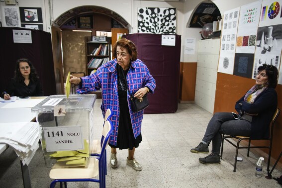 FILE - A woman votes at a polling station in Istanbul, Turkey, Sunday, May 14, 2023. With local elections across Turkey days away, legal experts are coaching thousands of volunteer election monitors on the rules they'll need to watch for fraud and ensure a fair vote. (AP Photo/Emrah Gurel, File)