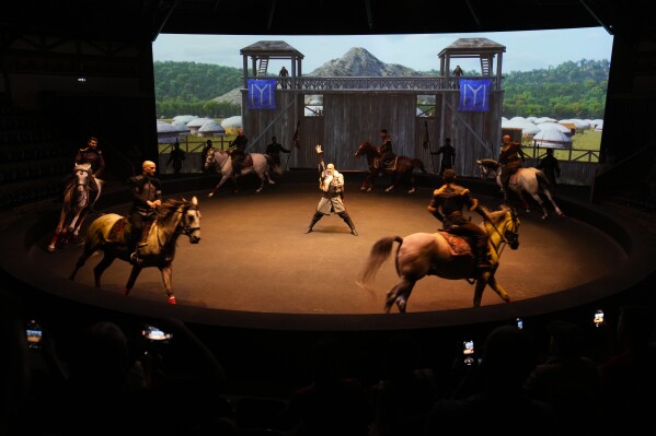 People present a horse riding performance for tourists during their visit in Bozdag's outdoor film studio in Istanbul, Turkey, Wednesday, June 12, 2024. (AP Photo/Khalil Hamra)