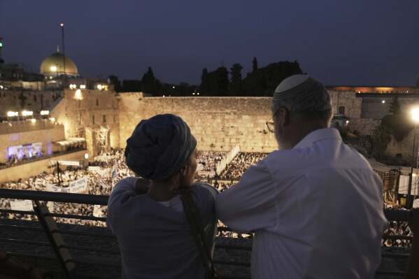 Israelis gather at the Western Wall, the holiest site where Jews can pray, to mark Jerusalem Day, an Israeli holiday celebrating the capture of east Jerusalem in the 1967 Mideast war, in Jerusalem's Old City, Monday, May 26, 2025. (AP Photo/Maya Alleruzzo)