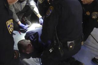 In this image taken from a nearly 18-minute video taken by a California Highway Patrol sergeant, Edward Bronstein, 38, is being taken into custody by CHP officers on March 31, 2020, following a traffic stop in Los Angeles. Bronstein died nearly two years ago as he screamed "I can't breathe" while multiple officers restrained him as they tried to take a blood sample, according to records and a video. The video was released Tuesday, March 15, 2022, after a judge's order to make it public. Bronstein's family has filed a federal lawsuit against the officers, alleging excessive force and a violation of civil rights. (California Highway Patrol via AP)